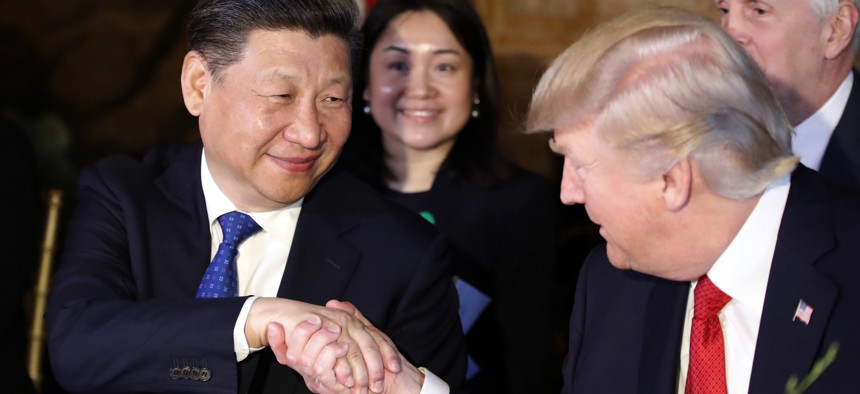 President Donald Trump, right, shakes hands with Chinese President Xi Jinping during a dinner at Mar-a-Lago, Thursday, April 6, 2017, in Palm Beach, Fla.