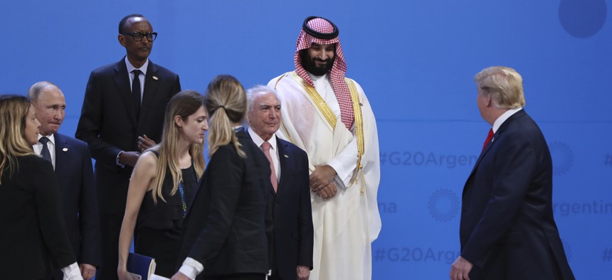 Saudi Arabia's Crown Prince Mohammed bin Salman, top right, watches President Donald Trump, right, walk past while leaders gather for a group photo at the start of the G20 summit in Buenos Aires, Argentina, Friday, Nov. 30, 2018.