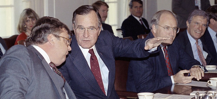 In this Nov. 13, 1990 photo, President George H. Bush talks with Deputy Secretary of State Lawrence Eagleburger at the start of Cabinet meeting at the White House in Washington.