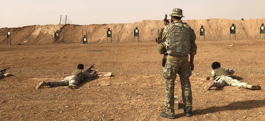 Members of the Maghawir al-Thawra Syrian opposition group receive firearms training from U.S. Army Special Forces soldiers at the al-Tanf military outpost in southern Syria on Monday, Oct. 22, 2018.