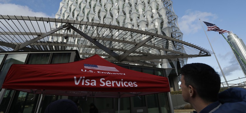 A Visa Services gazebo stands outside as the first group of Visa applicants to go into the new United States Embassy building in London, wait in line outside, Tuesday, Jan. 16, 2018.