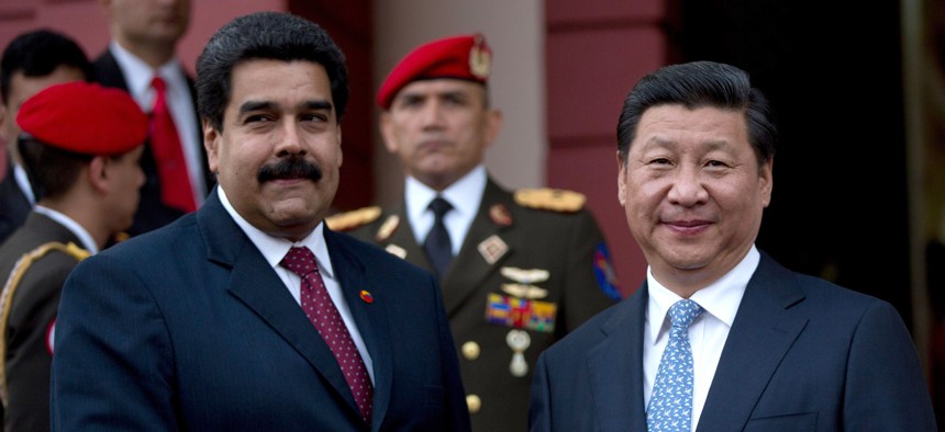 China's President Xi Jinping, right, shakes hand of Venezuela's President Nicolas Maduro, left, prior their meeting at Miraflores Presidential palace in Caracas, Venezuela, Sunday, July 20, 2014.