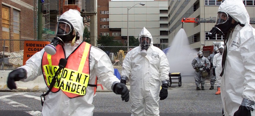 Baltimore City Fire Department Hazmat team battalion Chief Mark Wagner, left, guides operations during an emergency training exercise put on by the University of Maryland Medical Center and the U.S. Air Force to simulate a bioterror attack.