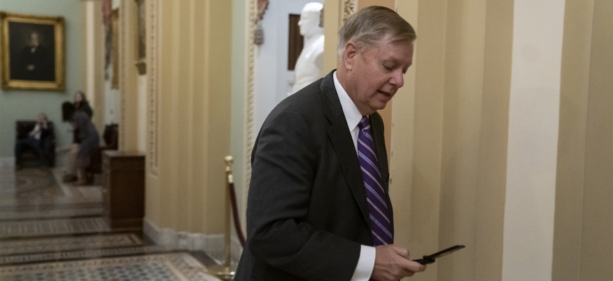Sen. Lindsey Graham, R-S.C., rushes to the office of Senate Majority Leader Mitch McConnell, R-Ky., on Dec. 19, 2018. Graham called Trump's apparent decision to withdraw all U.S. troops from Syria "a disaster in the making."