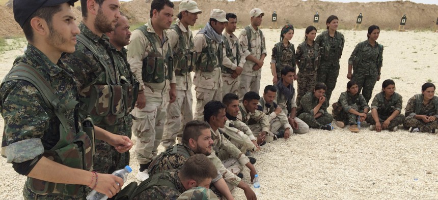 In this file photo taken May 21, 2016, members of what the U.S. calls the Syrian Democratic Forces gather after a training session at a firing range in northern Syria.