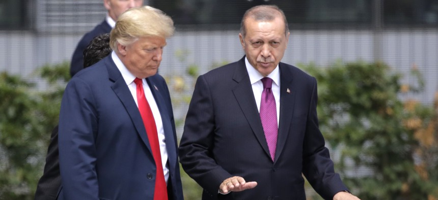 U.S. President Donald Trump, left, talks with Turkish President Recep Tayyip Erdogan during a summit of heads of state and government at NATO headquarters in Brussels Wednesday, July 11, 2018.