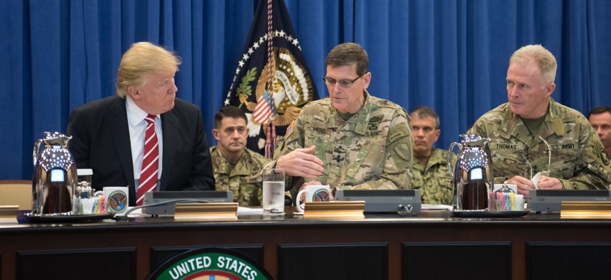President Donald Trump discusses current military operations with Gen. Joseph Votel, commander of U.S. Central Command Commander, and Gen. Raymond A. "Tony" Thomas, U.S. Special Operations Command Commander at MacDill, AFB, FL, Feb. 6, 2017. 