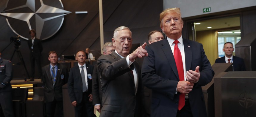 U.S. President Donald Trump, right, walks in with Defense Secretary Jim Mattis, left, as they arrive to attend the multilateral meeting of the North Atlantic Council, Wednesday, July 11, 2018 in Brussels, Belgium.