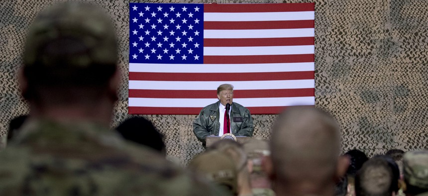 After ordering a withdrawal from Syria, President Donald Trump speaks to U.S. troops at Al Asad Air Base, Iraq, Wed., Dec. 26, 2018.