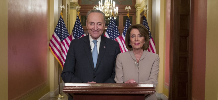 Senate Minority Leader Chuck Schumer of N.Y., and House Speaker Nancy Pelosi of Calif., pose for photographers after speaking on Capitol Hill in response President Donald Trump's address, Tuesday, Jan. 8, 2019.