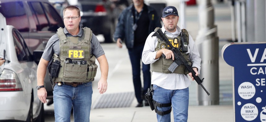 FBI agents walk outside the terminal at Fort Lauderdale–Hollywood International Airport, after a gunman opened fire on  Jan. 6, 2017, in Fort Lauderdale, Fla.