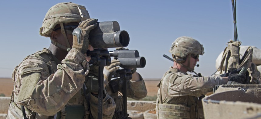 In this Nov. 1, 2018, photo released by the U.S. Army, soldiers surveil the area during a combined joint patrol in Manbij, Syria.