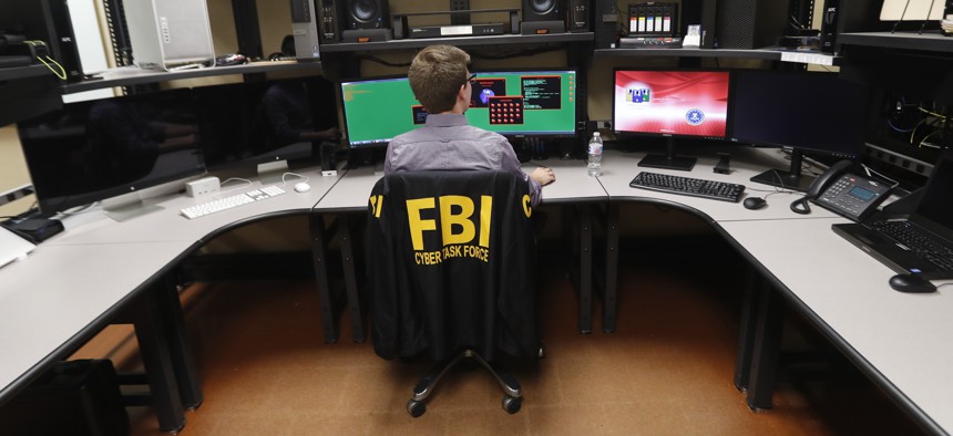 In this Tuesday, July 31, 2018, photo, an FBI employee works in a computer forensics lab at the FBI field office in New Orleans.