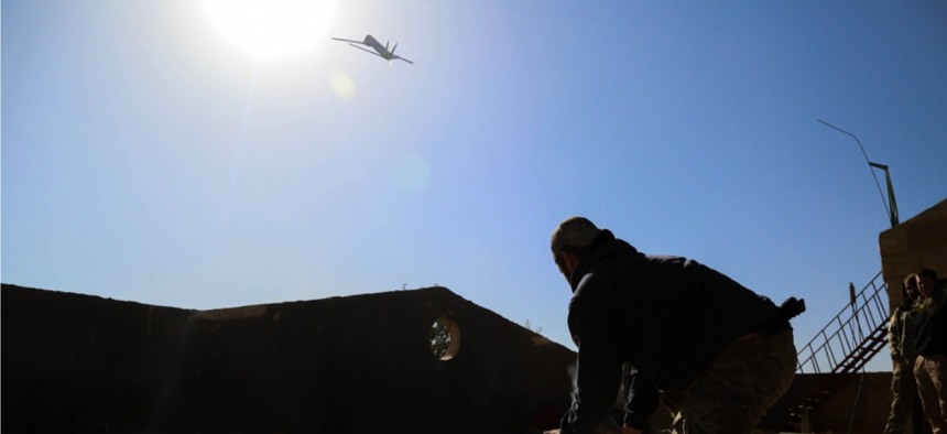 A Coalition Forces member launches an Unmanned Aerial Vehicle near Hajin, Syria, Jan 8, 2019.