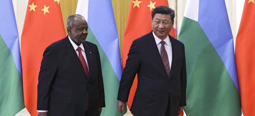 Djibouti's President Ismail Omar Guelleh, left, and Chinese President Xi Jinping walk for their bilateral meeting at the Great Hall of the People in Beijing, Sunday, Sept. 2, 2018.