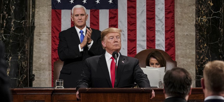 President Donald Trump gives his State of the Union address to a joint session of Congress, Tuesday, Feb. 5, 2019, at the Capitol in Washington, as Vice President Mike Pence, left, and House Speaker Nancy Pelosi look on.