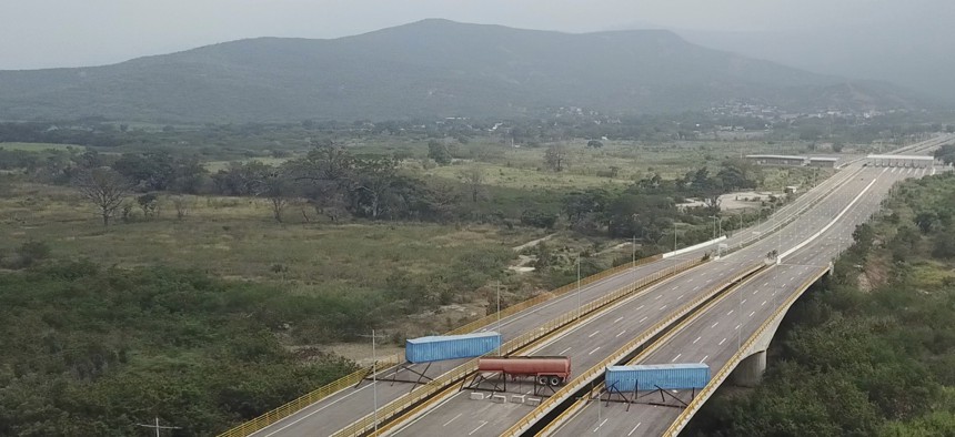 Trailers and cargo containers block the Tienditas International Bridge in an attempt to stop humanitarian aid entering from Colombia on Feb. 6, 2019. Immigration authorities say the Venezuelan National Guard built the roadblock a day earlier.