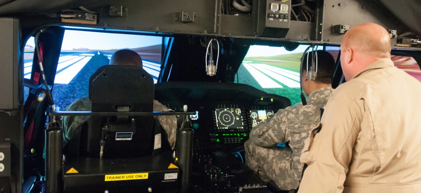 Pilots assigned to the 25th Combat Aviation Brigade, 25th Infantry Division, receive their first look and hands-on-experience with the new UH-60M Black Hawks on the Transportable Black Hawk Operations Simulator, Jan. 14, 2014. 