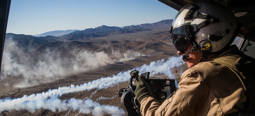 U.S. Marine Lance Cpl. Joseph Krieter looks from a UH-1Y Venom helicopter during an Integrated Training Exercise at Marine Corps Air Ground Combat Center Twentynine Palms, California, Nov. 9, 2018. 