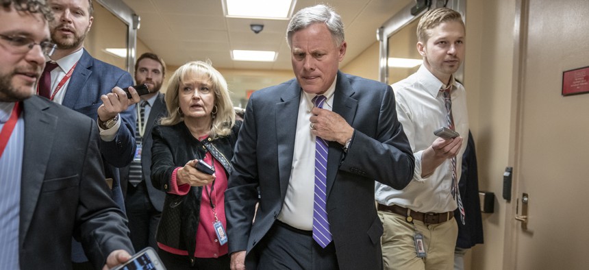 Senate Intelligence Committee Chairman Richard Burr, R-N.C., walks to the Senate as reporters ask questions, at the Capitol in Washington, Tuesday, Feb. 12, 2019.