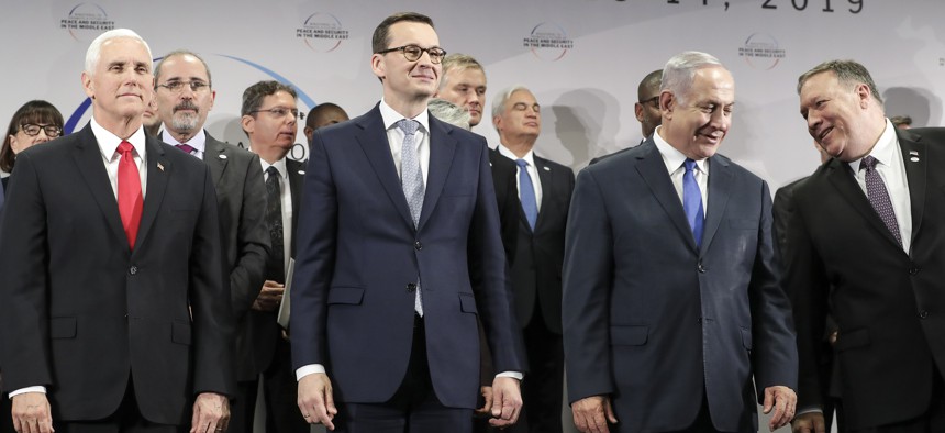 In this Feb. 14, 2019 photo, United States Vice President Mike Pence, Prime Minister of Poland Mateusz Morawiecki, and Israeli Prime Minister Benjamin Netanyahu stand on a podium at a conference in Warsaw, Poland.