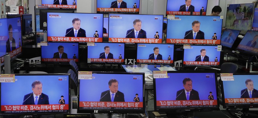 TV screens show the live broadcast of South Korean President Moon Jae-in's New Year press conference at an electronic shop in Seoul, South Korea, Thursday, Jan. 10, 2019.
