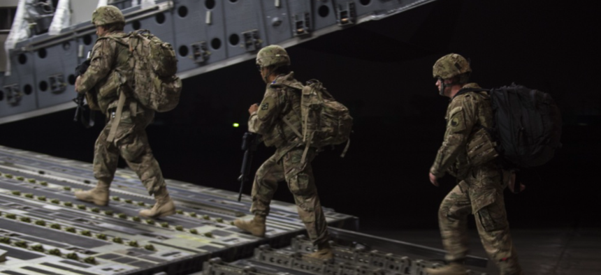 U.S. Army soldiers board a U.S. Air Force C-17 Globemaster III from the 816th Expeditionary Airlift Squadron for transport while the aircraft and its crew conduct combat airlift operations for U.S. and coalition forces in Iraq and Syria, Nov. 11, 2017.