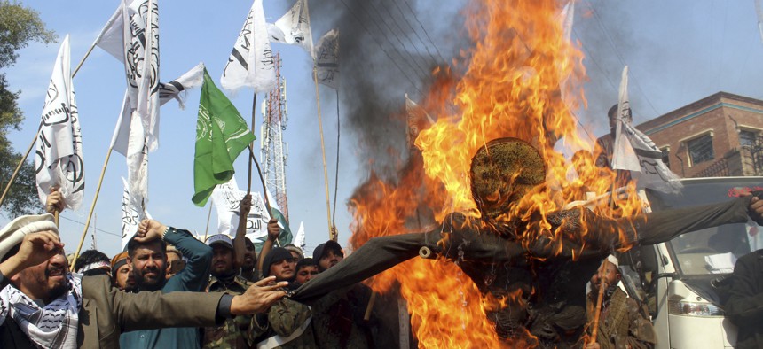 Pakistani protesters burn an effigy of Indian Prime Minister Narendra Modi during an anti-Indian rally in Peshawar, Pakistan, Thursday, Feb. 28, 2019.