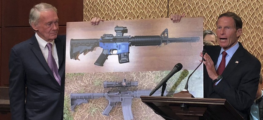 Sen. Edward Markey, D-Mass., left, and Sen. Richard Blumenthal, D-Ct., display a photo of a plastic gun on Tuesday, July 31, 2018, on Capitol Hill in Washington.