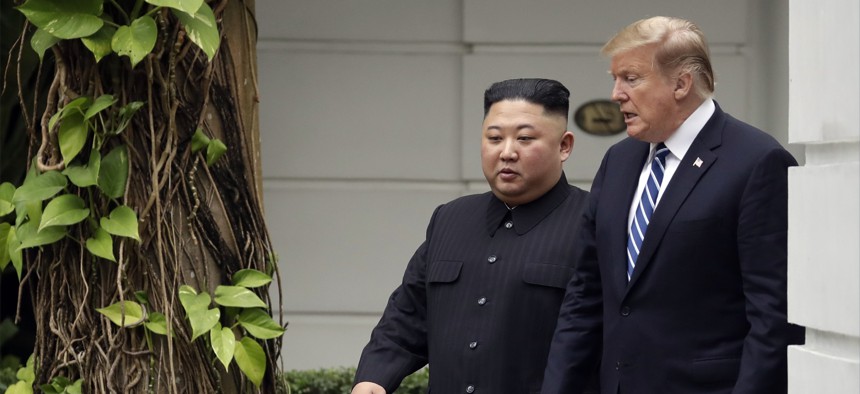President Donald Trump and North Korean leader Kim Jong Un take a walk after their first meeting at the Sofitel Legend Metropole Hanoi hotel, Thursday, Feb. 28, 2019, in Hanoi.