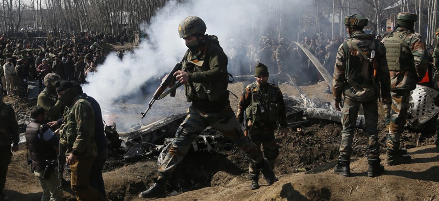  In this Wednesday, Feb.27, 2019 file photo, Indian army soldiers arrive at the wreckage of an Indian helicopter after it crashed killing several in the Budgam area, on the outskirts of Srinagar, Indian controlled Kashmir.