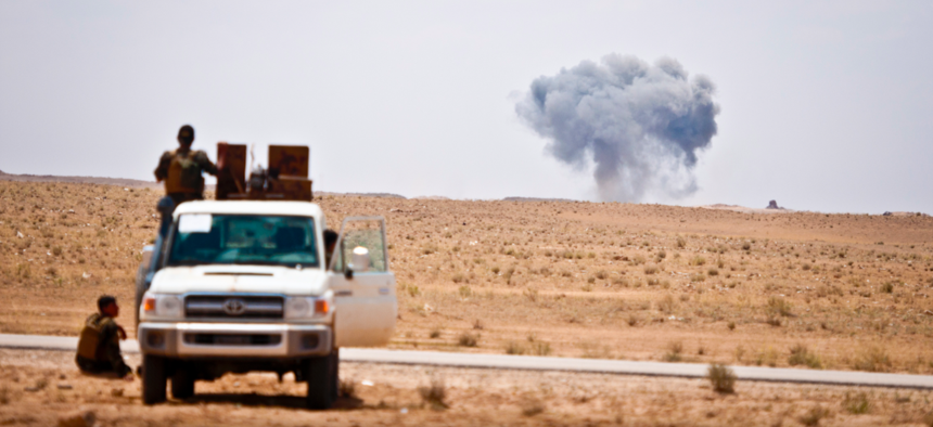 Syrian Democratic Forces watch as a Coalition airstrike hits its target on a known ISIS location near the Iraqi-Syrian border, May 13, 2018.