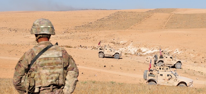 U.S. Soldiers observe Turkish forces in the distance during a patrol outside Manbij, Syria, Aug. 19, 2018. 