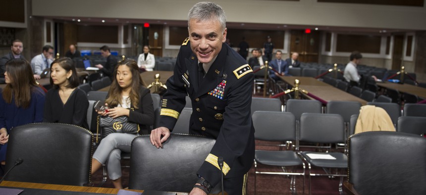 Army Lieutenant General Paul Nakasone arrives at the witness table to appear before the Senate Armed Services Committee to discuss his qualifications as nominee to be National Security Agency Director and U.S. Cyber Command Commander, during a hearing on 
