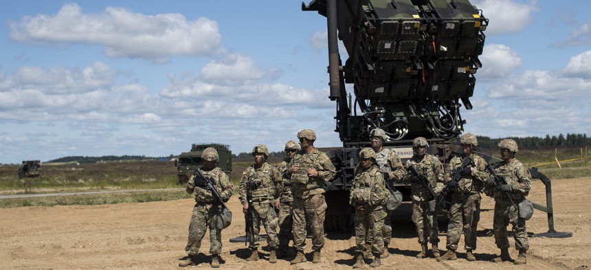 Members of US 10th Army Air and Missile Defense Command stands next to a Patriot surface-to-air missile battery during the NATO exercise "Tobruq Legacy 2017" at the Siauliai airbase near Vilnius, Lithuania, July 20, 2017. 