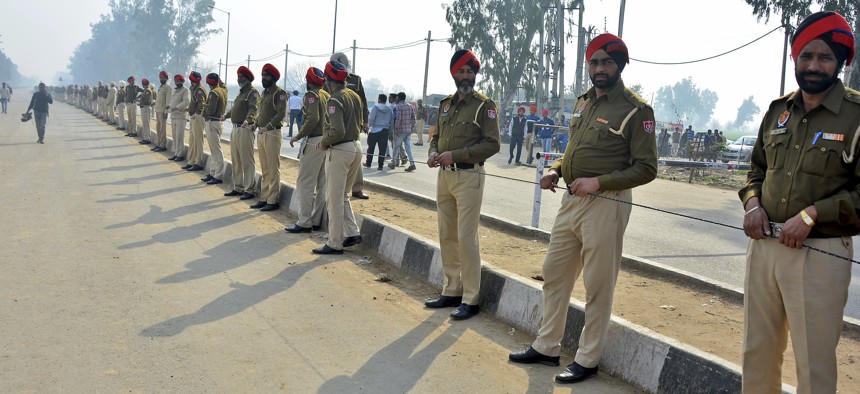Indian policemen stand guard as they prepare to receive Indian pilot at India Pakistan border at Wagah, 28 kilometers (17.5 miles) from Amritsar, India, Friday, March 1, 2019.