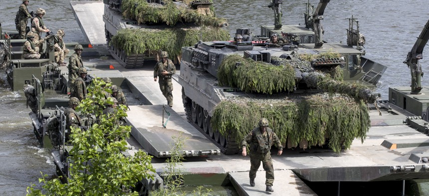 German Army soldiers dismantle a bridge over the Neris river during the NATO military exercise 'Iron Wolf 2017' at the village Stasenai, some 130kms (80 miles) west-north of the capital Vilnius, Lithuania, Tuesday, June 20, 2017.
