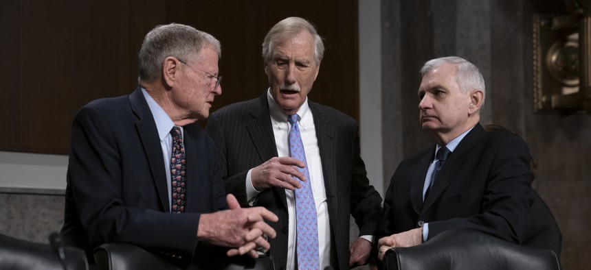 From left, Senate Armed Services Committee Chairman Jim Inhofe, R-Okla., Sen. Angus King, I-Maine, and Ranking Member Jack Reed, D-R.I., confer before a hearing on the Pentagon budget, on Capitol Hill in Washington, March 14, 2019.