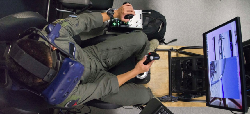 U.S. Air Force Second Lt. Christopher Ahn, Pilot Training Next student, trains on a virtual reality flight simulator, at the Armed Forces Reserve Center in Austin, Texas, June 21, 2018. 