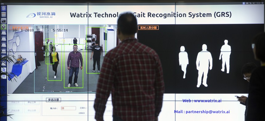 In this Oct. 31, 2018, photo, Watrix employees demonstrate their firm's gait recognition software at their company's offices in Beijing. A Chinese technology startup hopes to begin selling software that recognizes people by their body shape gait.