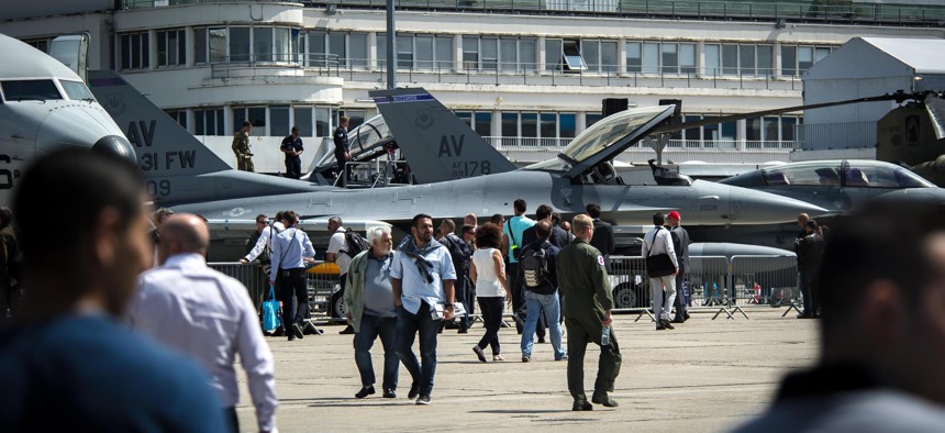 Crowds of industry professionals and media tour a pair of F-16 Fighting Falcons from Aviano Air Base, Italy, during the 51st International Paris Air Show at Le Bourget Airport, France, June 16, 2015.