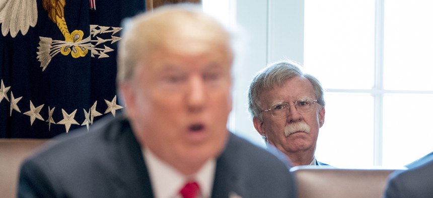 National security adviser John Bolton listens as President Donald Trump speaks at the White House in August 2018, in Washington.