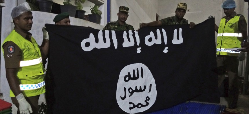 Sri Lankan police show an ISIS flag recovered from alleged hideout of militants, the week following Easter Sunday attacks claimed by the group, Friday, April 26, 2019