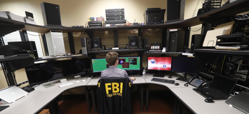 In this Tuesday, July 31, 2018, photo, an FBI employee works in a computer forensics lab at the FBI field office in New Orleans.