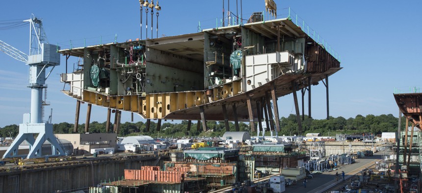 Newport News Shipbuilders lifted a 704-metric-ton aunit into Dry Dock 12, where construction of the aircraft carrier USS John F. Kennedy (CVN-79) is taking shape. 