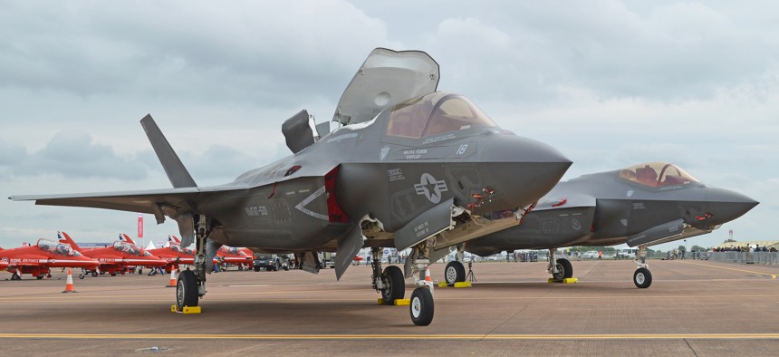 A US Marine Corps F-35B sits in front of a US Air Force F-25A at the 2016 Royal International Air Tattoo, Fairford, UK.
