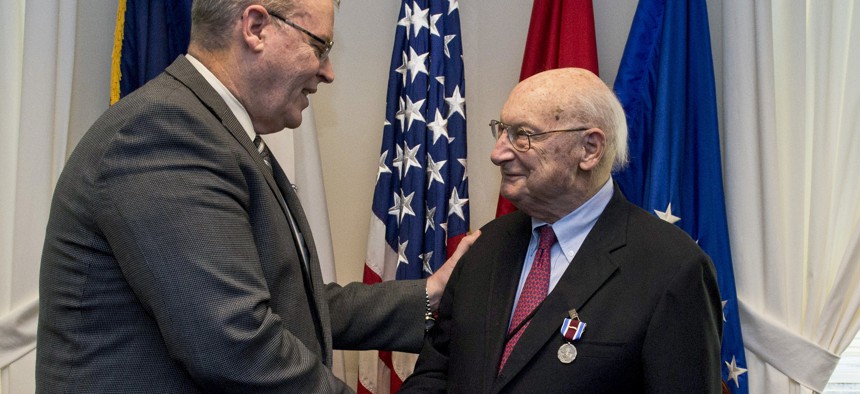 Deputy Defense Secretary Bob Work hosts a farewell ceremony for Andrew M. Marshall at the Pentagon, Jan. 5, 2015. Marshall, 93, worked his last day as director of the Defense Department's Office of Net Assessment, retiring after 42 years.