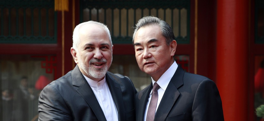 Iranian Foreign Minister Mohammad Javad Zarif, left, and his Chinese counterpart Wang Yi shake hands during their meeting at the Diaoyutai State Guesthouse in Beijing Tuesday, Feb. 19, 2019.