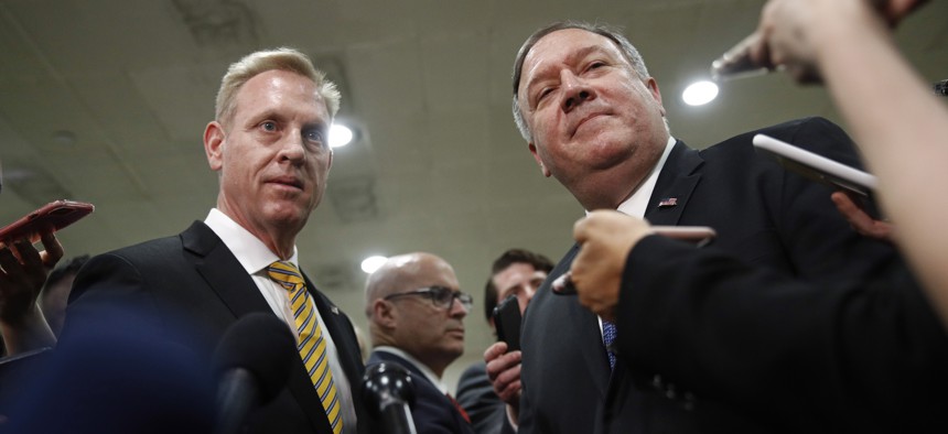 Acting Defense Secretary Patrick Shanahan, left, and Secretary of State Mike Pompeo speak to members of the media after a classified briefing for members of Congress on Iran, Tuesday, May 21, 2019, on Capitol Hill in Washington. 