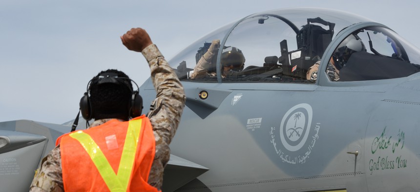 A Royal Saudi Air Force airman gestures to a F-15SA flight crew during Red Flag at Nellis Air Force Base in March 19
